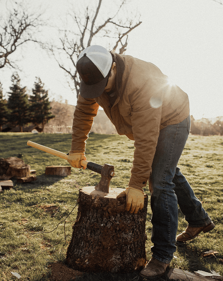 Man chopping wood at Shannon Ridge