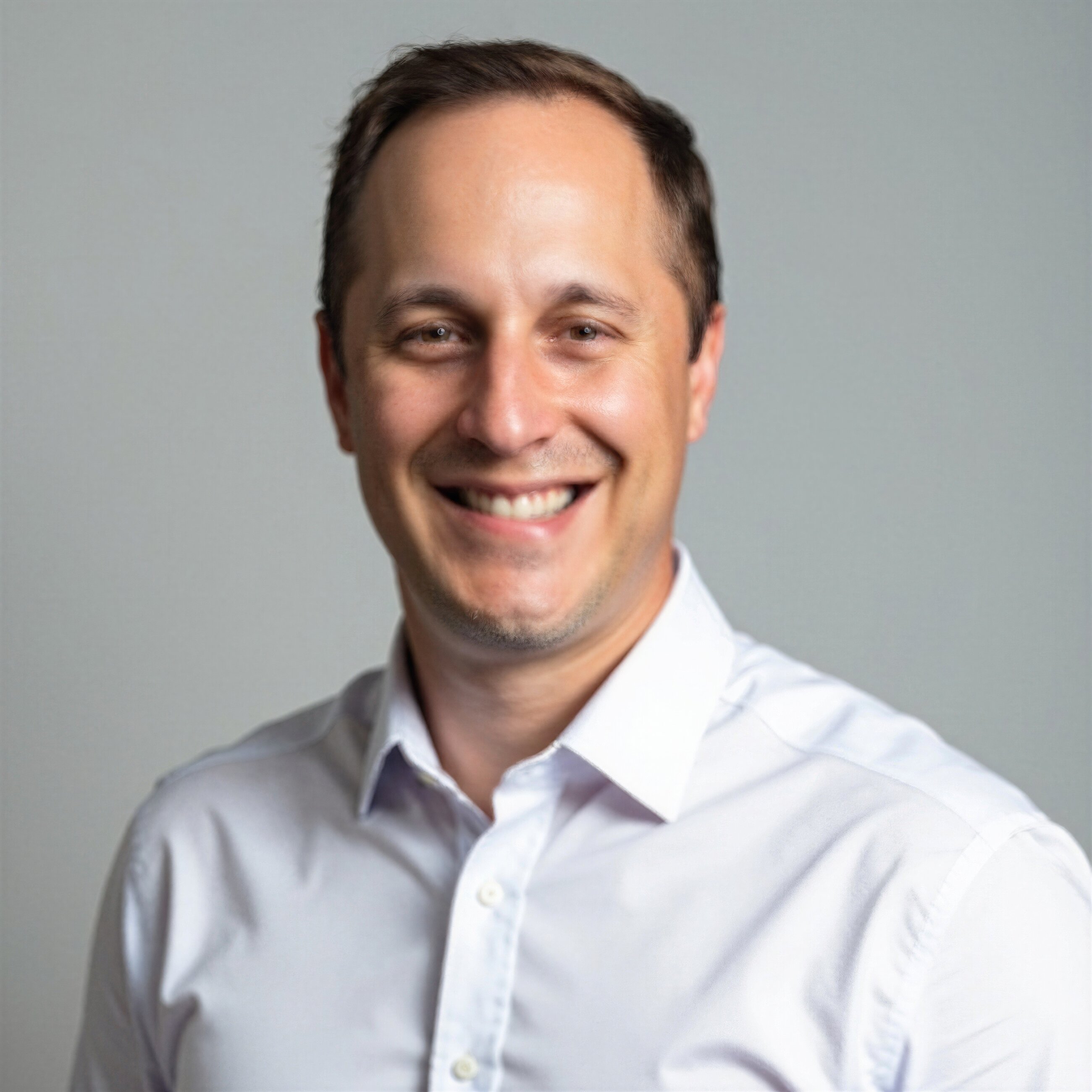 Portrait of a smiling man in a white shirt, representing the Shannon Family of Wines team.